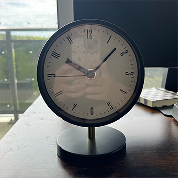 Complex geometry object 3:black, white, and gold clock, front view.