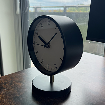 Complex geometry object 3:black, white, and gold clock, side view.